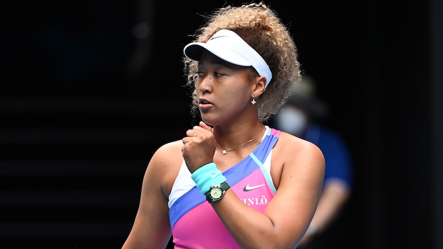 A female Japanese tennis player pumps her left fist at the Australian Open.