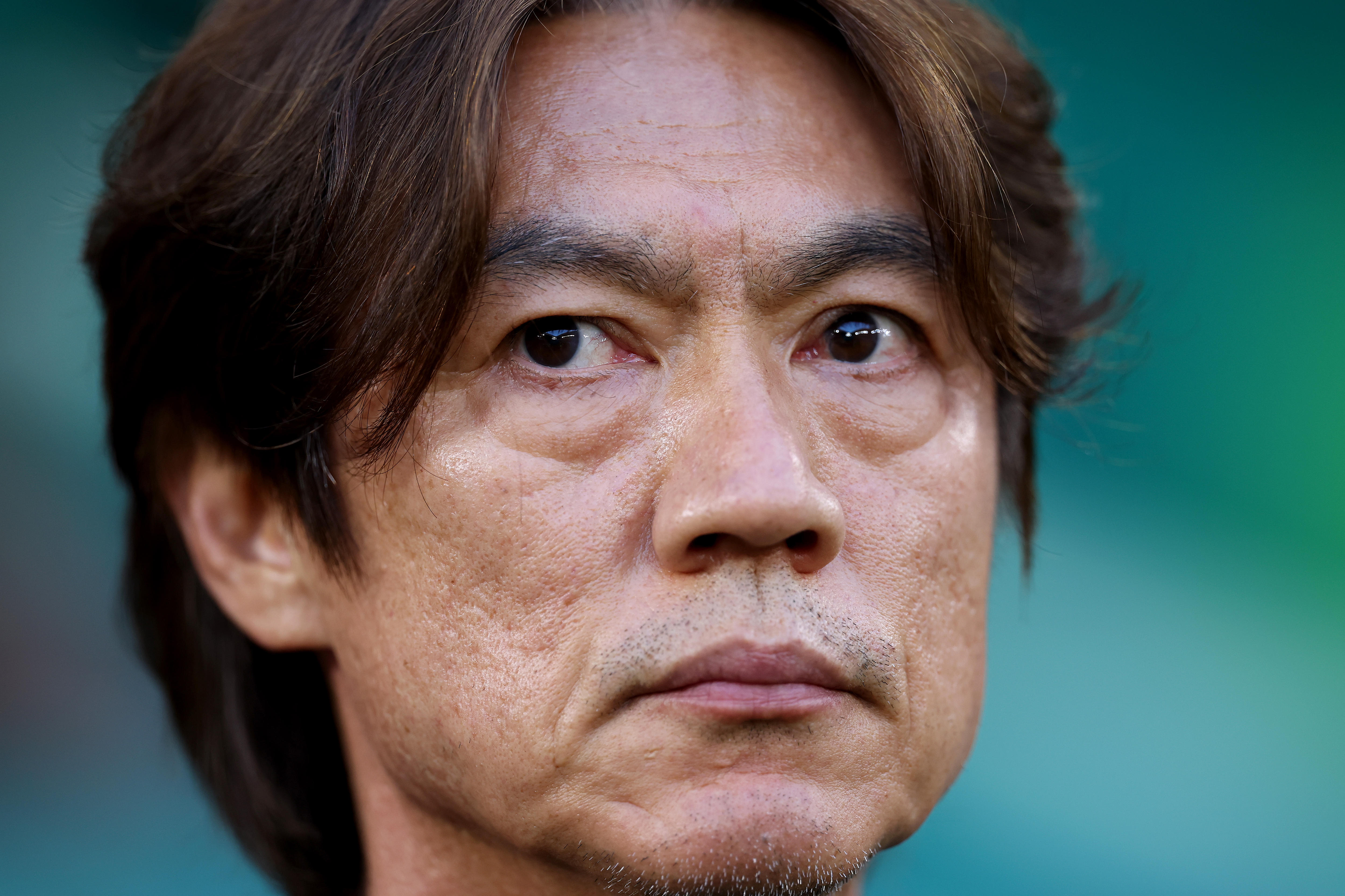 Myung-Bo Hong looks to one side