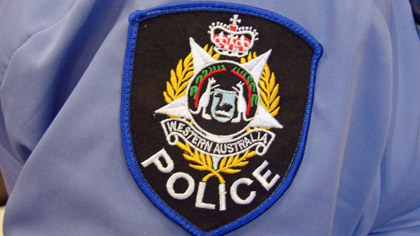 WA police badge on an officer's sleeve.