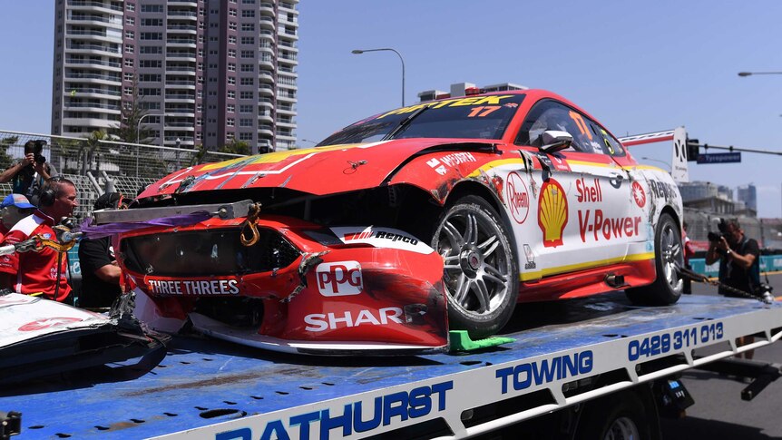 A Mustang emblazoned with Shell sponsorships and sporting a smashed-up bumper sits on a flatbed truck.