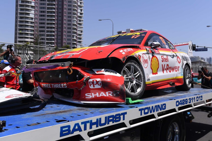 A Mustang emblazoned with Shell sponsorships and sporting a smashed-up bumper sits on a flatbed truck.