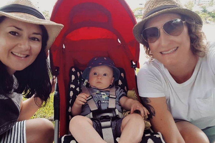 Tanya and Julia with their son in a pram