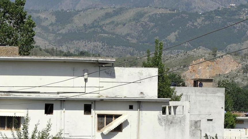 People gather outside the compound where Osama bin Laden was killed.