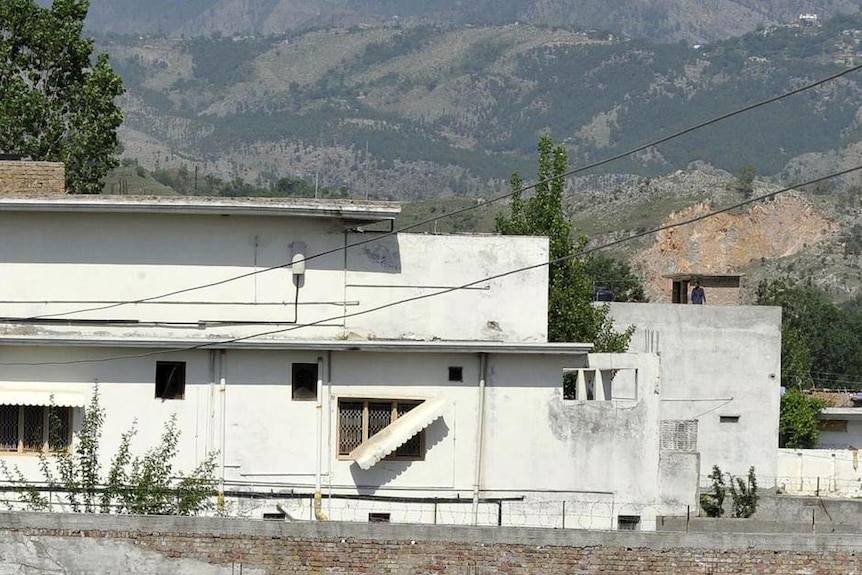 People gather outside the compound where Osama bin Laden was killed