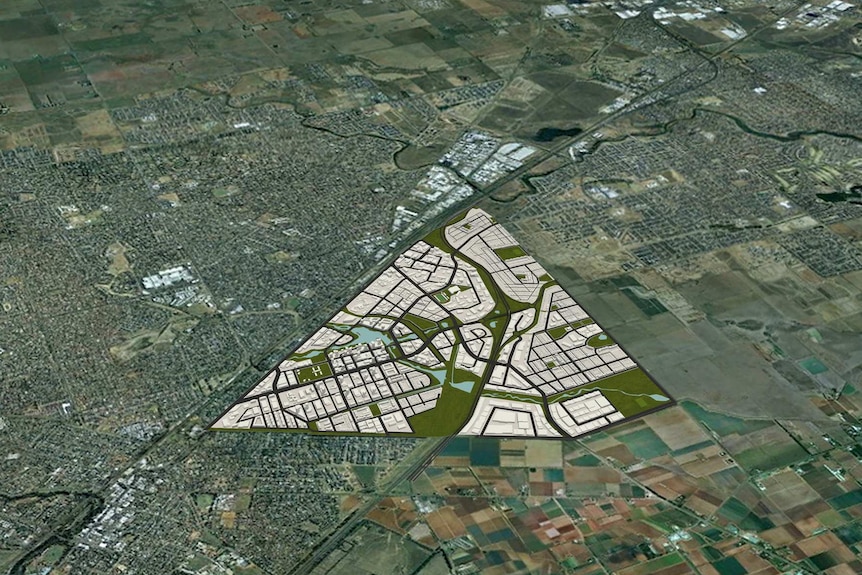 Aerial shot of a regional town with a computer-generated image of a new development suburb superimposed next to town.