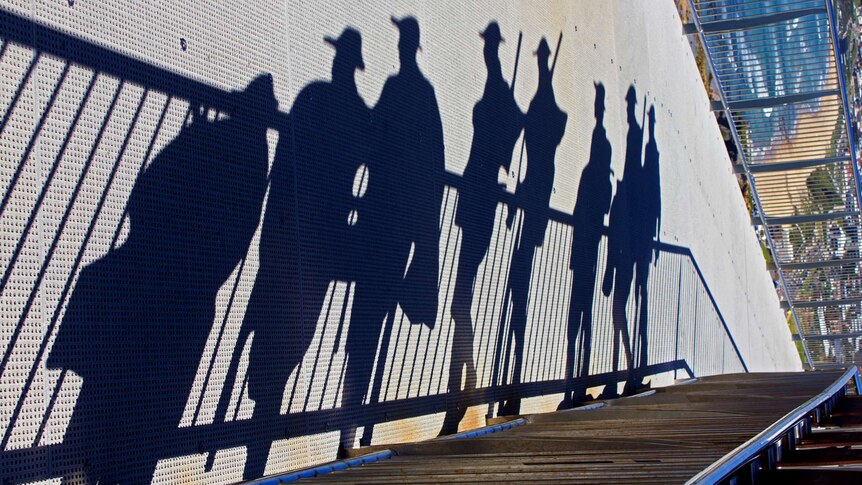 Shadows of soldiers against wall