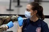Female firefighter gets a Moderna COVID-19 vaccination in Las Vegas, Nevada.