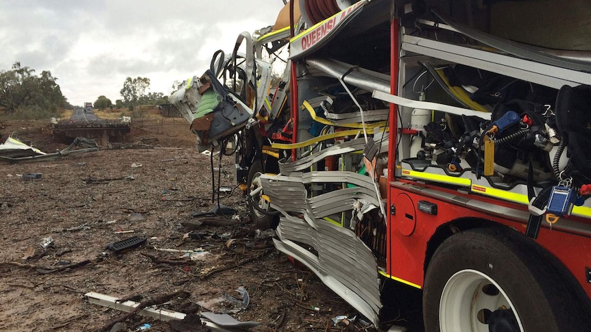 Damaged fire vehicle and crater at scene of major truck explosion south of Charleville in south-west Queensland
