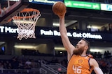 Aron Baynes flies through the air with the ball, arm extended and ready to dunk.