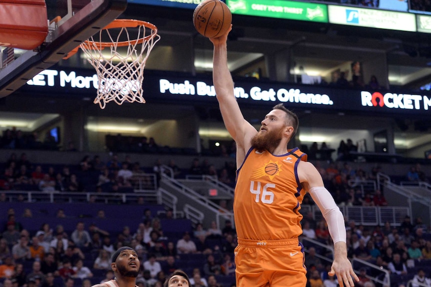 Aron Baynes flies through the air with the ball, arm extended and ready to dunk.