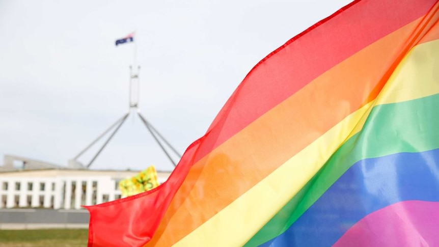 Rainbow flag flying outside Australian Parliament House.
