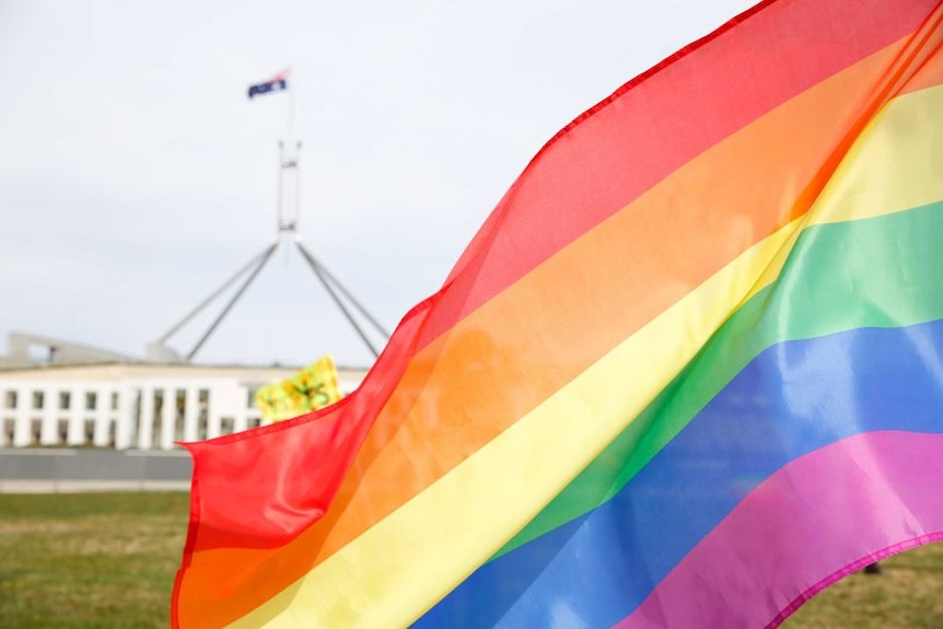 Rainbow flag flying outside Australian Parliament House.