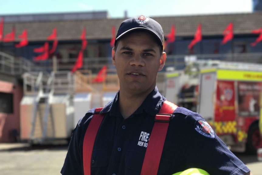 A man standing in front of fire engine.