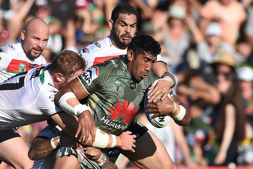 Iosia Soliola of the Raiders is tackled