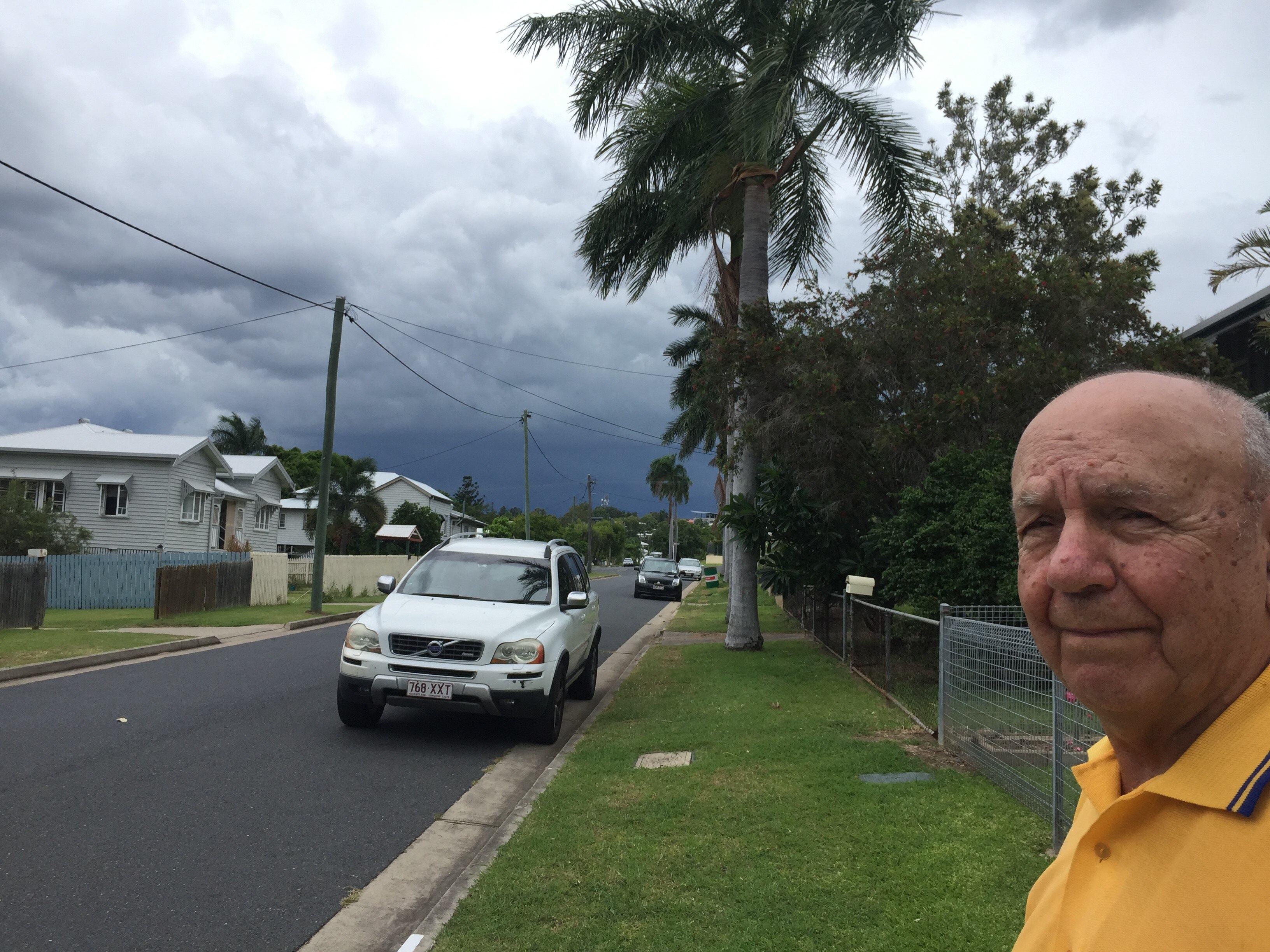 Doug Hoare looks down his street as a thunderstorm approaches Rockhampton