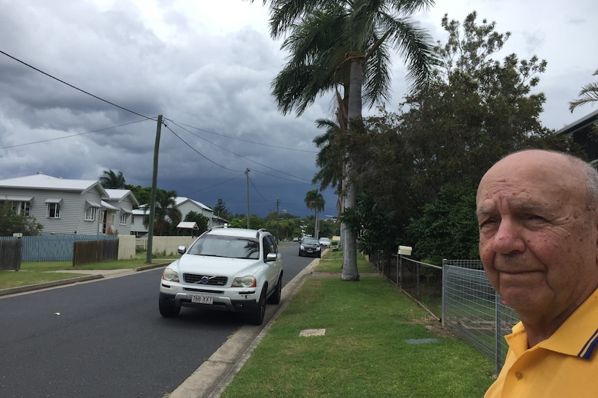 Doug Hoare looks down his street as a thunderstorm approaches Rockhampton