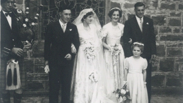 A 1940s wedding featuring a bride and groom with a bridesmaid, best man and flower girl.