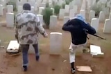Two men allegedly kick down headstones at the Benghazi War Cemetery.