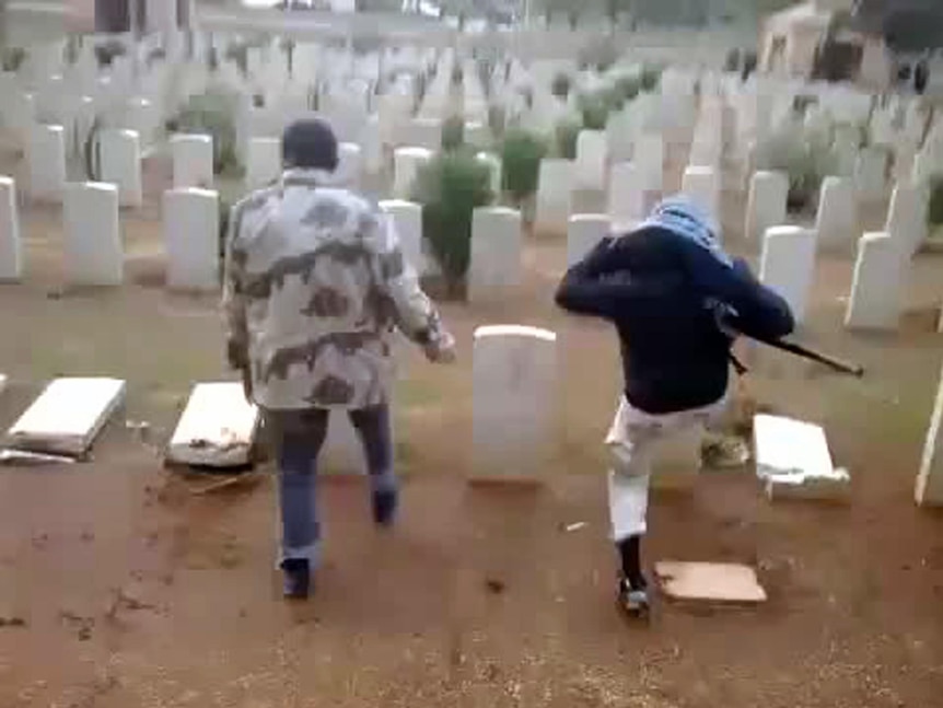 Two men allegedly kick down headstones at the Benghazi War Cemetery.