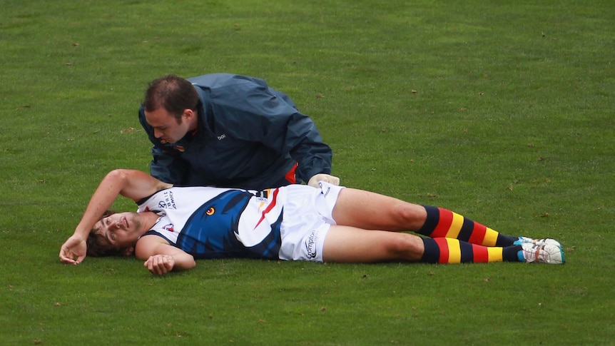 Ricky Henderson is treated by medical staff