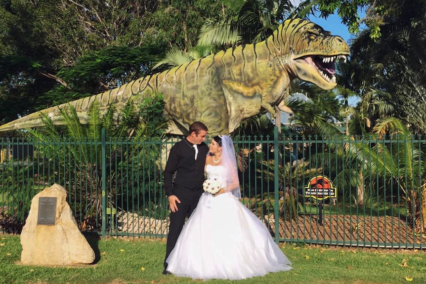 Married couple with T-Rex at vet surgery.