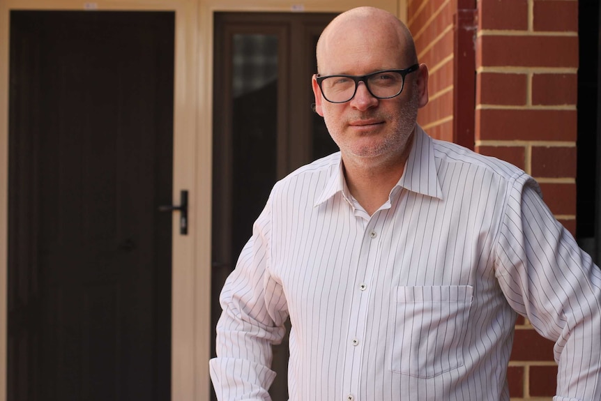 Martin Drum standing in the doorway of his home