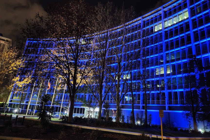 WA Police headquarters in Perth lit up in blue at night.