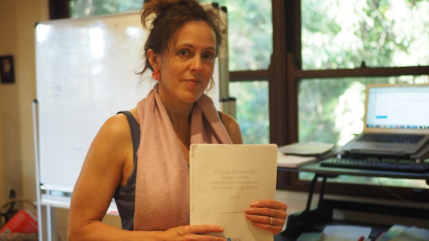 Woman in front of window with thick paper file