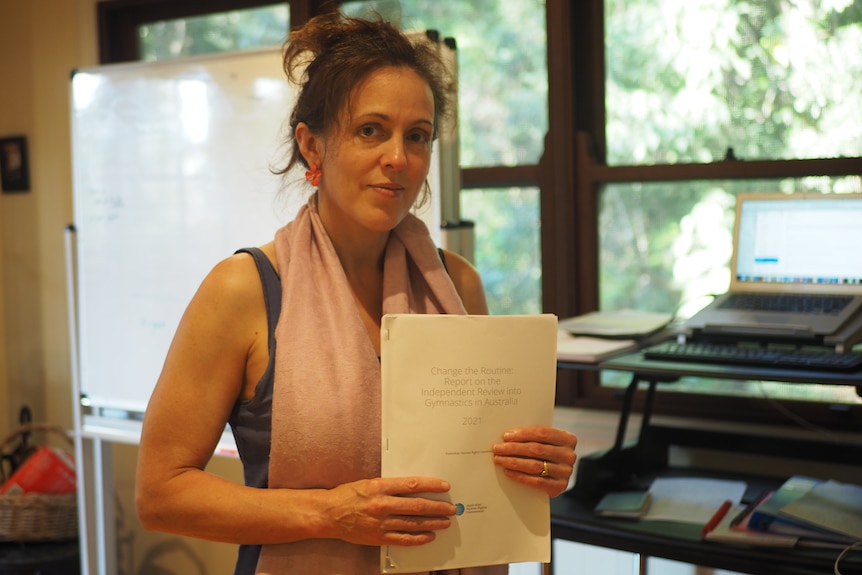 Woman in front of window with thick paper file