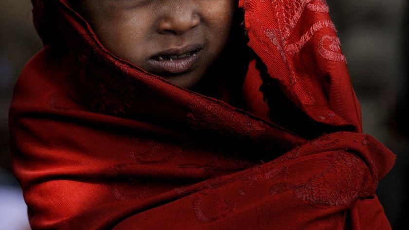 An Ethiopian girl wraps herself in a shawl