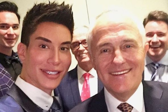 A well manicured man poses for a selfie with a smiling Prime Minister Malcolm Turnbull