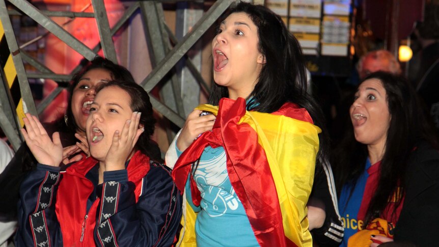 Spanish fans watching the Euro 2012 final celebrate their team's third goal.