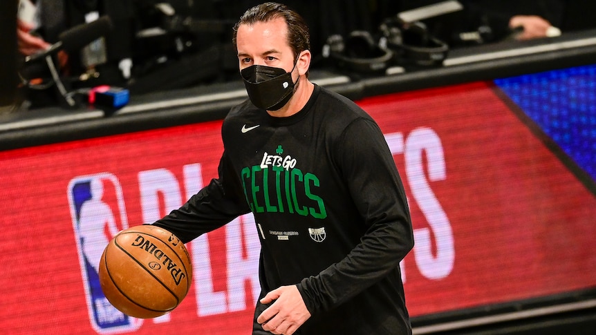 Scott Morrison holding a basketball and wearing a Celtics t-shirt.