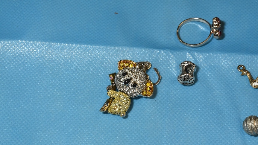 A small, jewel encrusted brooch or possible key-ring shaped as a koala