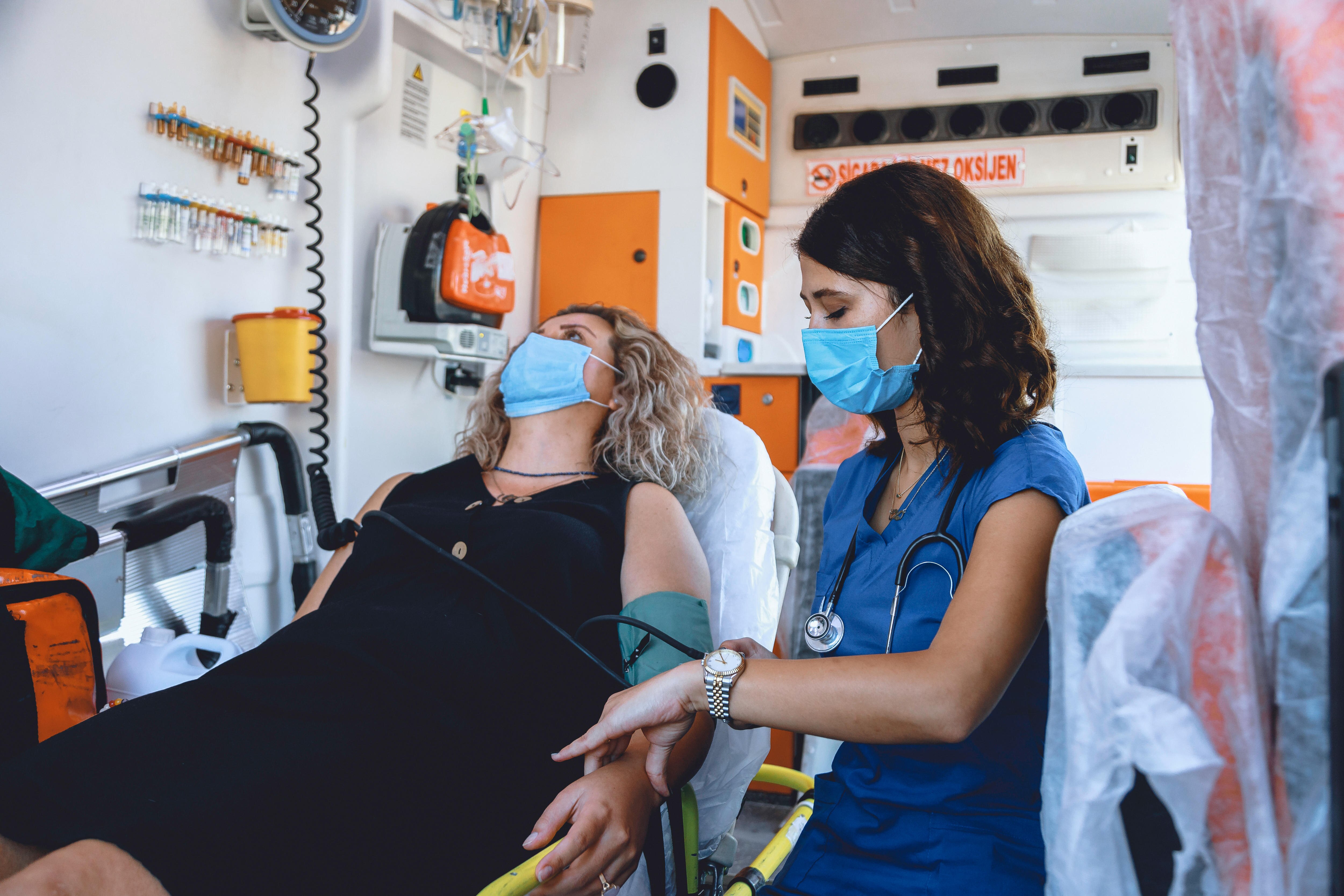Emergency nurse and woman patient COVID 19