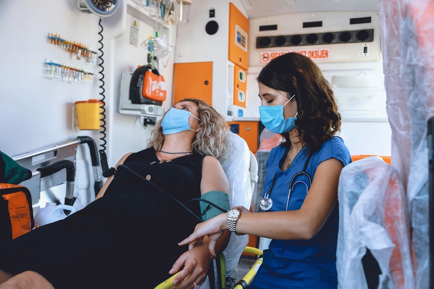 Emergency nurse and woman patient COVID 19