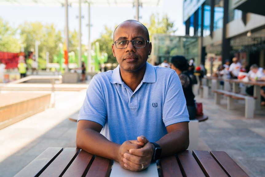 Professor Atakelty Haliu sitting at a table in the Perth CBD.