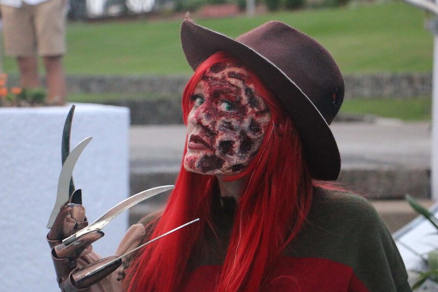A woman dresses up as horror film character Freddy Krueger