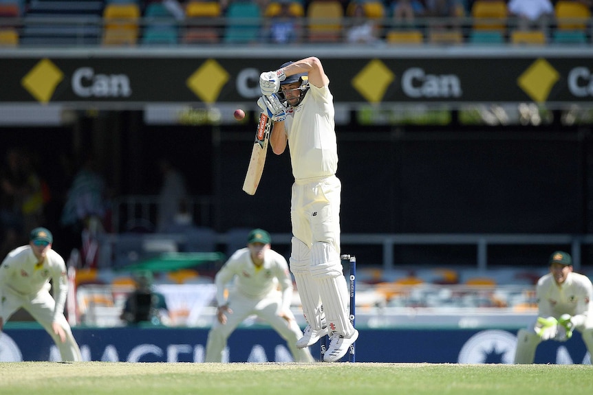 England batsman Chris Woakes fends off a ball in front of his face.