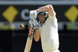 England batsman Chris Woakes fends off a ball in front of his face.