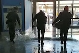 Workers sweep water out of John F Kennedy Airport after a burst water main flooded part of terminal four.