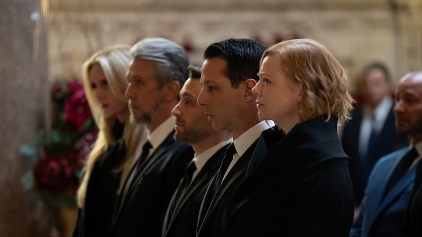 The Roy siblings stand shoulder to shoulder at a funeral.