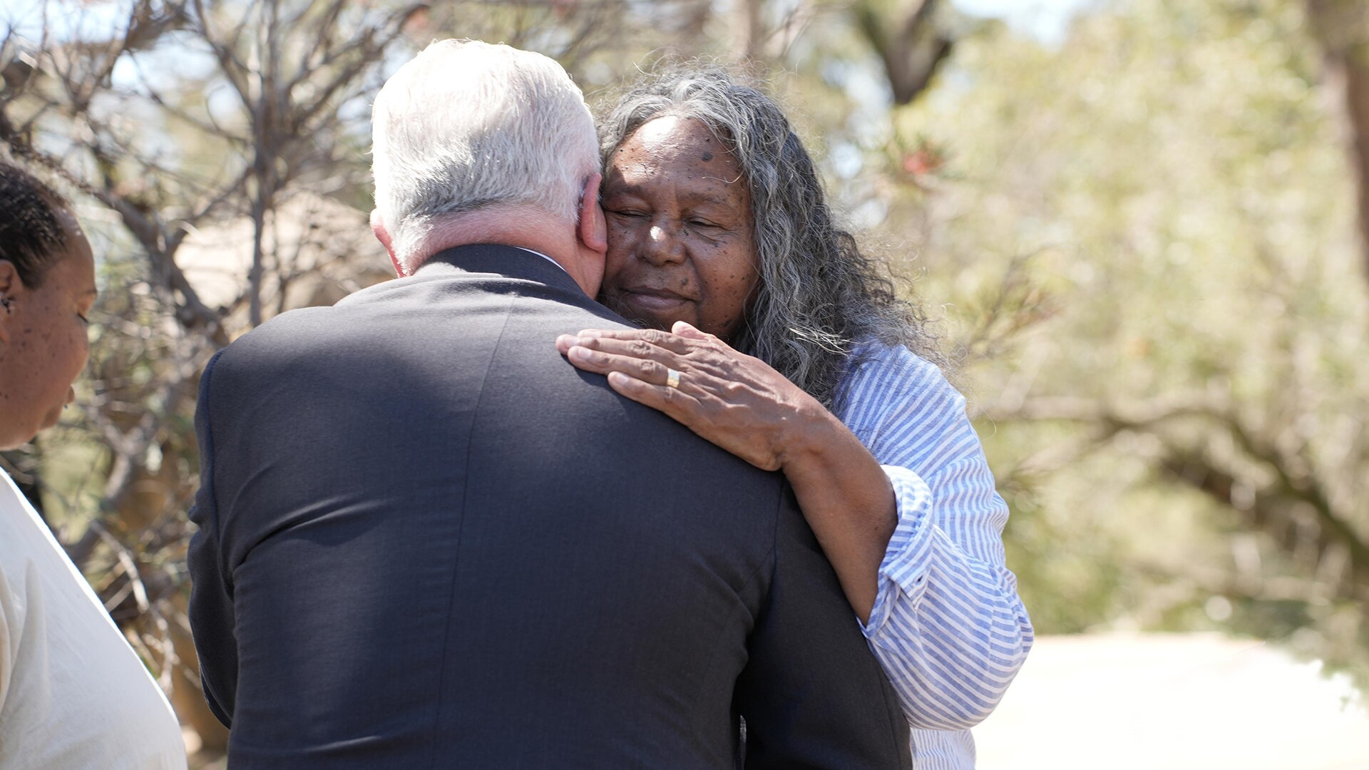 Indigenous woman Gloria embraces the Governor General at the ceremony.