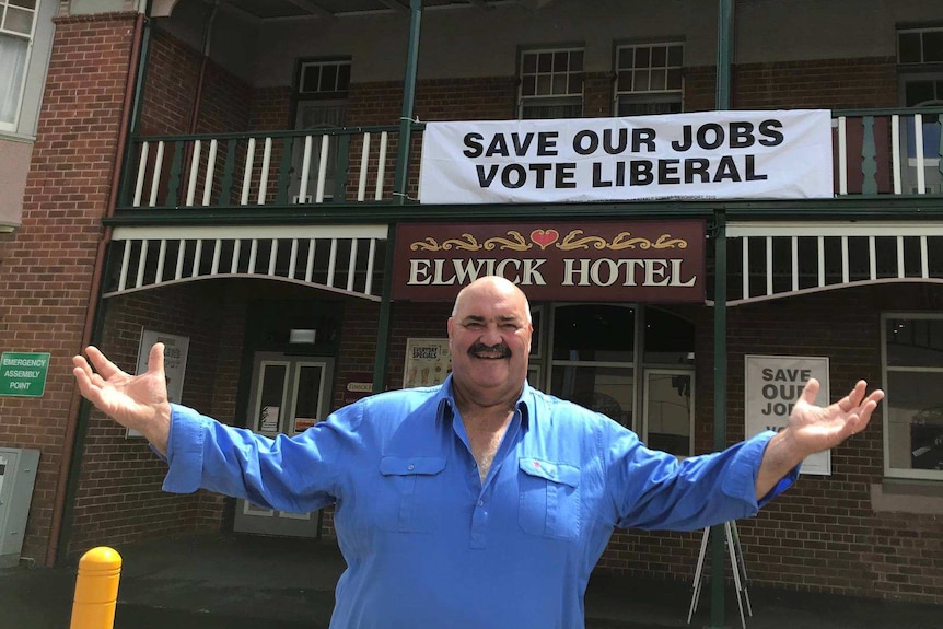 Champion woodchopper David Foster raising his hands outside the Elwick Hotel, Glenorchy, January 2018.