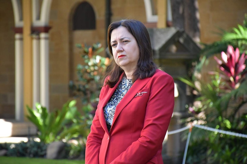 Annastacia Palaszczuk listens at a media conference in Brisbane.