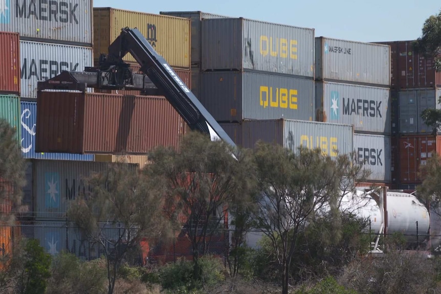 A crane lifts a shipping container at a terminal in Melbourne.