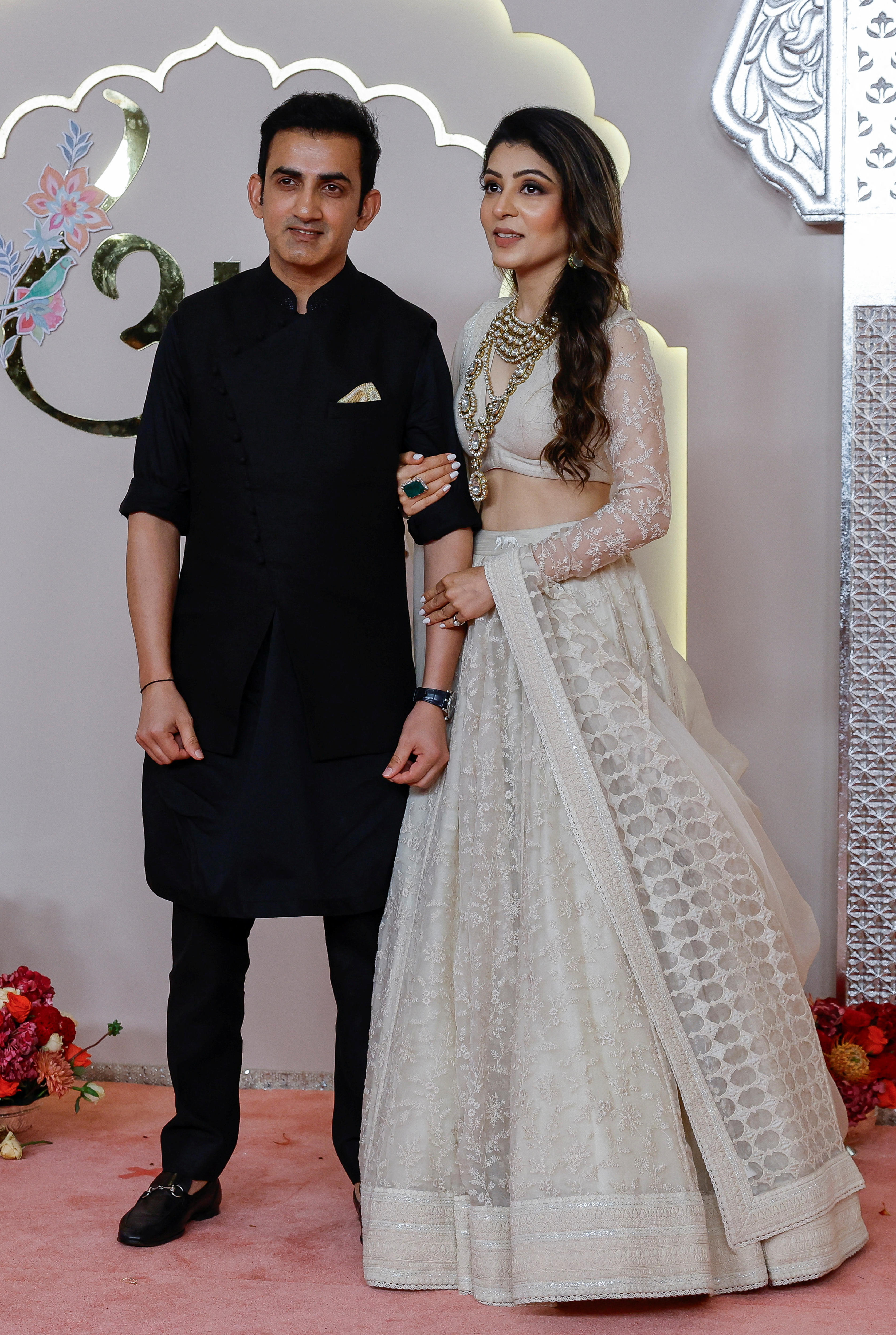  Gautam Gambhir wearing a black tunic and black trousers, while Natasha Jain wears a silvery skirt and long sleeve crop top