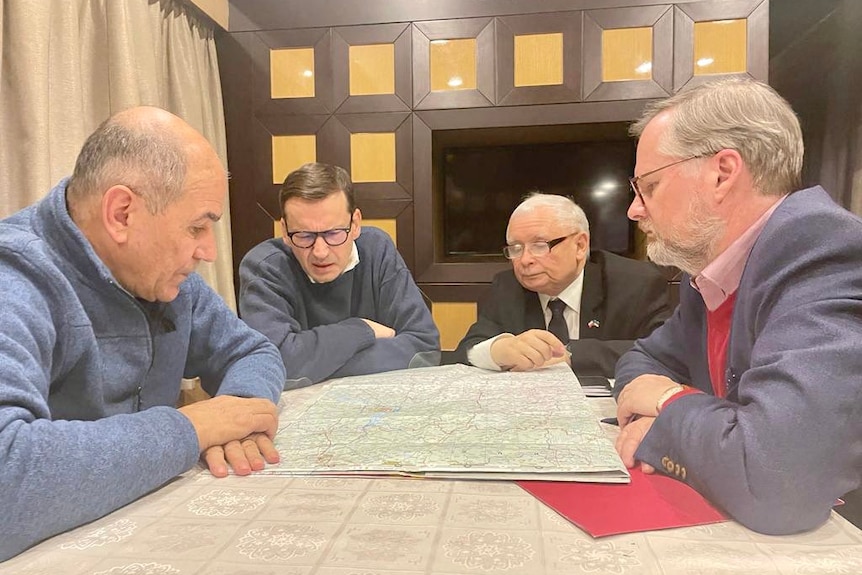 EU leaders sit around a map of Ukraine.