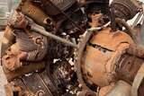 Old plane engine covered in rust
