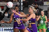 Tippha Dwan (centre) of the Queensland Firebirds reaches out for the ball